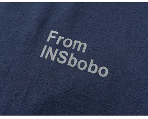 Close-up detail of navy blue knitted fabric texture on the children's cotton t-shirt