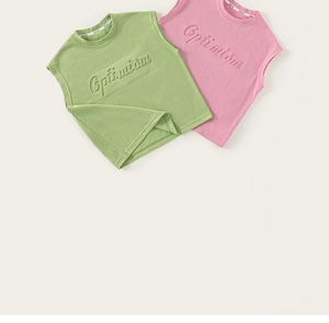 Detail of soft knit cotton vests featuring embossed Optimism text in pink and green