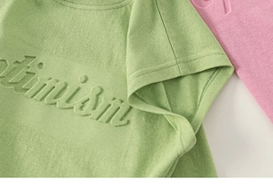 Detail of embossed optimism text on premium cotton knitted sleeveless vest