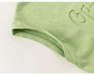 Detailed macro view of green cotton knit sleeve with 3D embossed lettering and fine stitching