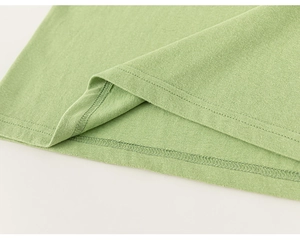 Detail view of avocado green cotton fabric showing precise double-needle hem stitching