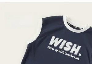 Detailed view of kids navy sleeveless tank top featuring white contrast piping and lettering