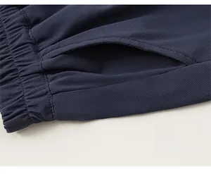 Detailed close-up of breathable mesh fabric and elastic waistband on boy's navy shorts