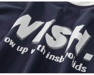 Close-up of breathable navy blue mesh fabric with white printed lettering for kids' sportswear