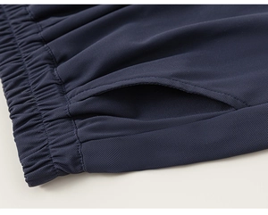 Detail of navy mesh shorts with elastic waistband and high-quality stitching texture