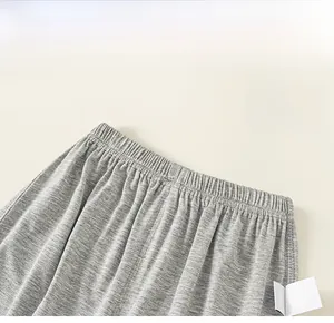 Detail of elastic waistband on grey knitted kids trousers with flexible stretch fit