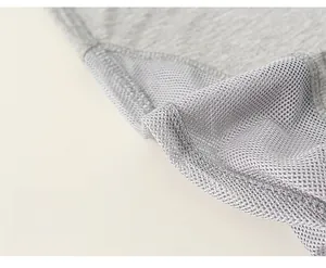 Close-up of high-quality light gray mesh and jersey fabric with precise stitching details