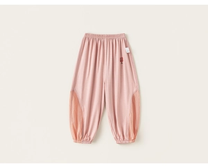 Detail of light pink kids mosquito pants with orange mesh panels and heart embroidery