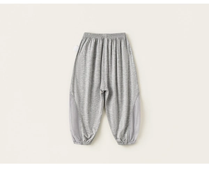 Detail of gray kids joggers featuring breathable mesh panels and elastic cuffs for summer