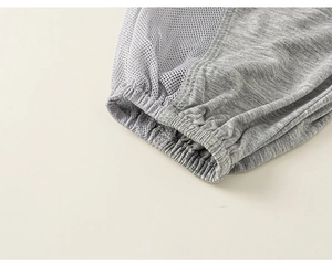 Detail of gray mosquito pants showing breathable mesh fabric and elastic ribbed cuffs