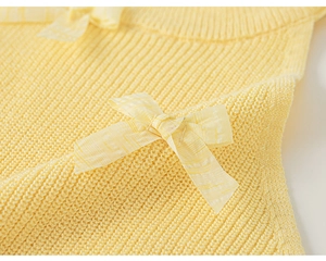 Close-up of yellow ribbed knit sleeveless top featuring a cute plaid texture bow detail