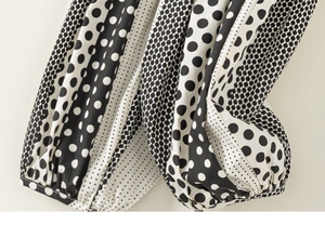 Detailed view of lightweight kids mosquito pants featuring stylish black and white polka dots