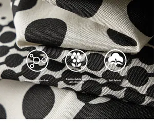 Macro shot of breathable polka dot cotton fabric showing soft texture and high-density weave