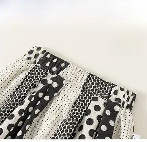 Detail of elastic waist and polka dot print on children fashion trousers for girls