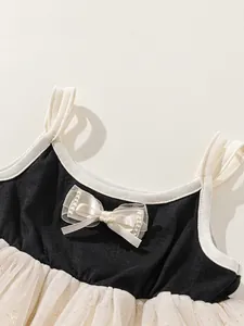 Girl's tutu dress in black and white contrast with sequined mesh and pearl bow detail