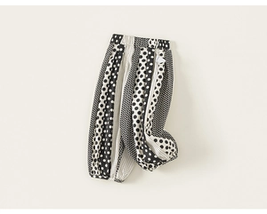 Close-up of girls' black and white polka dot harem pants with elastic cuffs and waist