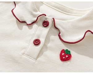 Detail of baby girl polo shirt featuring scallop collar with strawberry embroidery