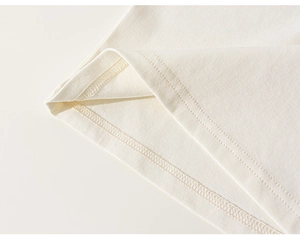 Detailed close-up of smooth double-needle stitching on cotton T-shirt hem