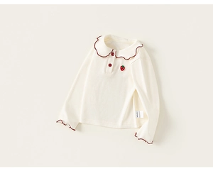 Detail of baby girl cream knit top with red scalloped collar and strawberry embroidery