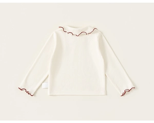 Detailed close-up of the ruffled doll collar with burgundy stitching on kids cotton top