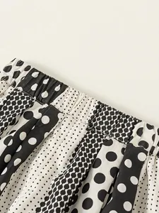 Girl's summer mosquito pants with polka dot print and elastic waistband in black and white