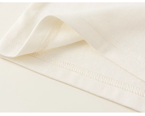 Macro detail of high-quality double-needle stitching on children's soft cotton T-shirt hem