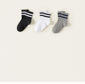 Detailed view of three pairs of striped cotton crew socks in black, white, and grey colors