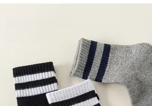 Detailed macro view of seamless knitted cotton striped socks in black, white and grey