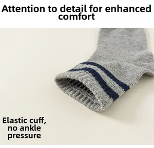 Detail of grey knitted kids socks with blue stripes and high elasticity ribbed cuff