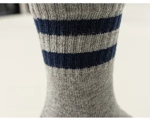 Close-up of striped design on gray and blue cotton blend knit mid-calf kids socks
