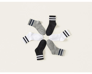Three pairs of striped cotton socks in black white and gray shown in a radial arrangement