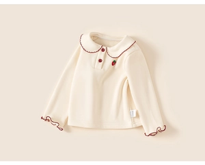 Close-up of baby girl top with Peter Pan collar, strawberry embroidery and ruffled cuffs