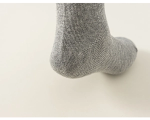 Detail view of the reinforced heel and stitching on children gray cotton socks