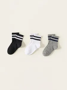 Three-pack of kids' cotton socks in black, white, and grey with striped athletic cuffs