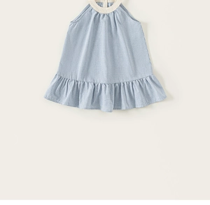 Detail view of children's blue gingham halter dress with ruffle hem and breathable cotton fabric