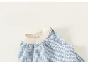 Close-up of blue and white checkered cotton fabric with soft skin-friendly texture