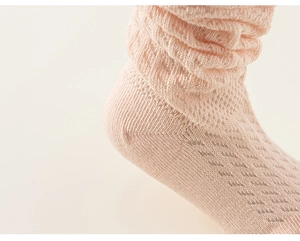 Gros plan de chaussettes en maille rose respirante pour filles en coton doux de qualité