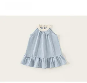 Detail of blue gingham pattern children's dress with ruffled hem and sleeveless design