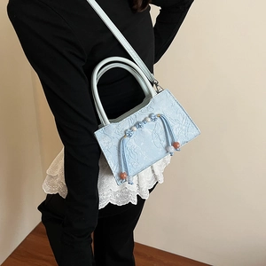 Elegant light blue lace handbag with beaded tassels and floral texture for women