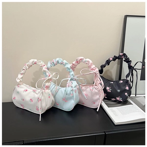 Detail showing pleated floral handbags in four colors with ruffled handles and bows