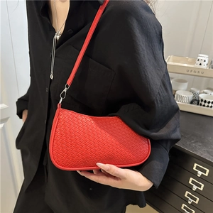 Minimalist bright red woven leather shoulder bag with sleek silver hardware and strap