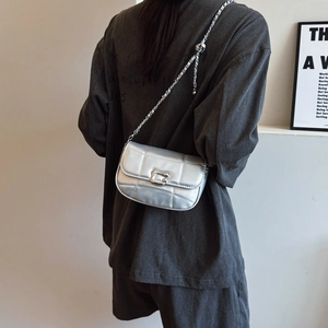 Silver quilted metallic chain bag for women with minimalist industrial design buckle