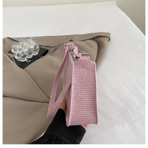 Detail of pink woven texture shoulder bag with metallic sequins and silver hardware accents