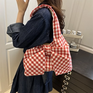 Red gingham bow-shaped canvas tote bag for women shown with denim dress styling