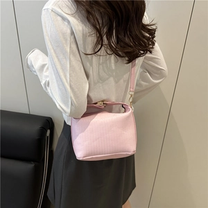 Pale pink vertical striped crossbody bag with gold metal hardware and slim strap