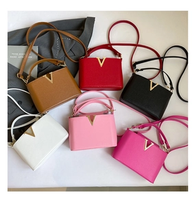 Selection of six colors of small square leather bags with elegant gold V decoration
