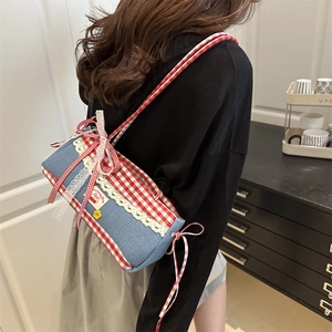 Blue denim shoulder bag with red plaid trim and ballet style lace bow detail