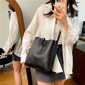 Classic black leather bucket bag with gold buckle and long shoulder strap for women