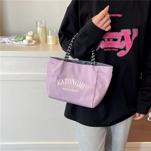 Chic purple dopamine tote bag with woven handles shown in a lifestyle setting