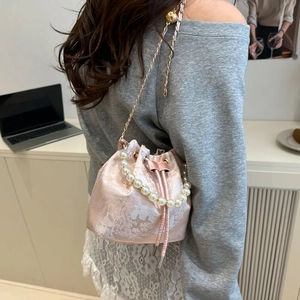 Pink silk bucket bag with Chinese floral embroidery and elegant pearl handle strap